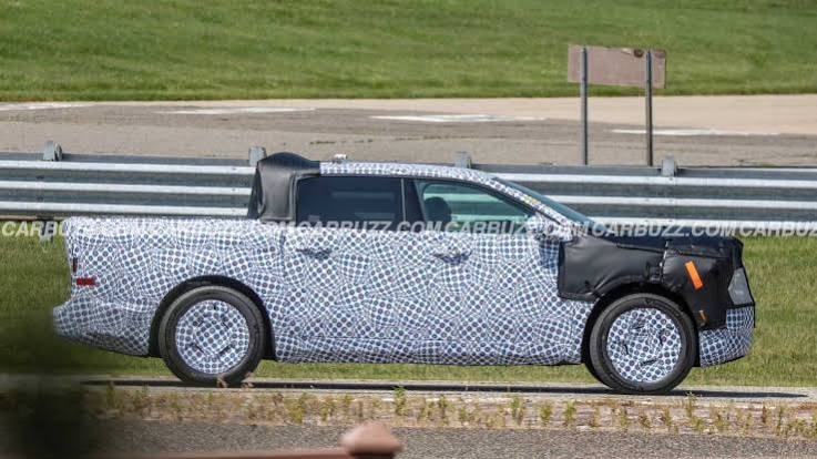 Ford Fathom prototype spy shot — camouflaged truck on a test track, side profile view